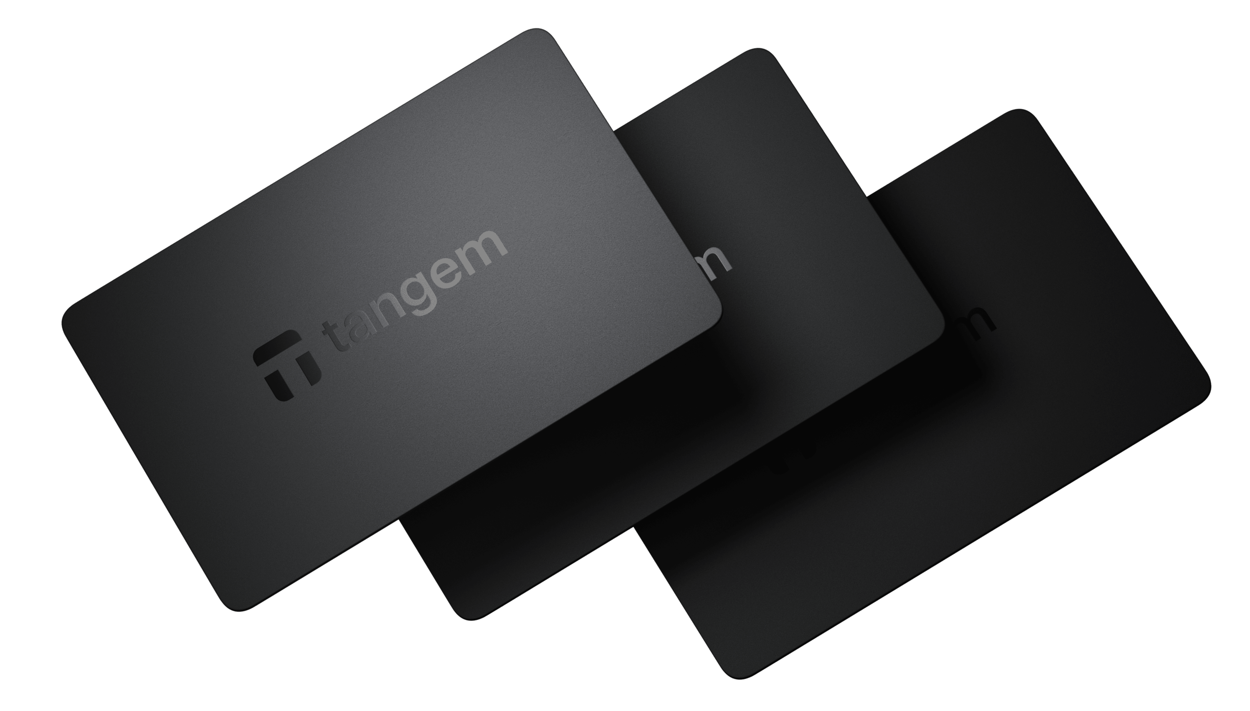 Tangem Wallet card placed next to a smartphone displaying Toncoin (TON) balance in the Tangem app