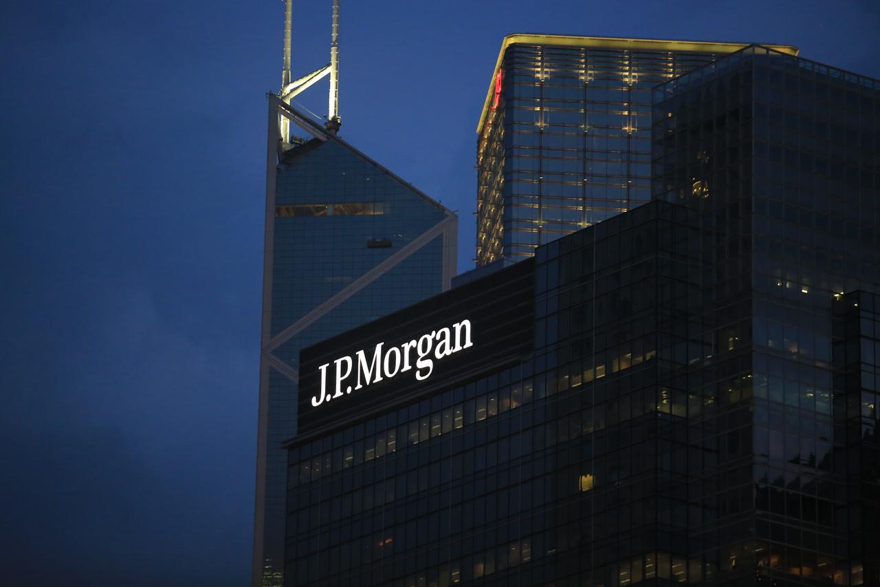 Handshake over smartphone showing Coinbase and JPMorgan Chase logos symbolizing partnership for seamless crypto buying