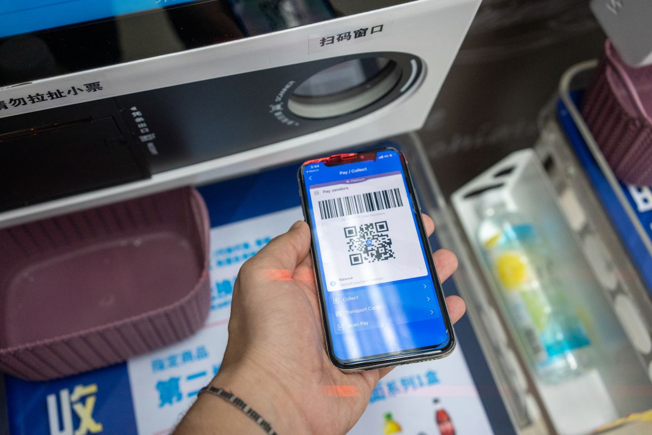 Vibrant Asian street vendor in bustling market holding QR code sign for offline USDC stablecoin payments, customers scanning with smartphones for quick crypto transactions