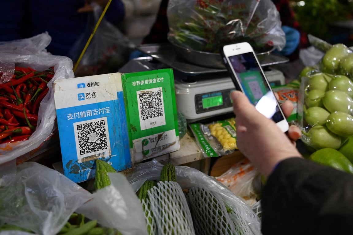 Vibrant street vendor in emerging market scanning QR code for USDC stablecoin payment with smartphone, enabling offline crypto transactions for USDT and digital dollars